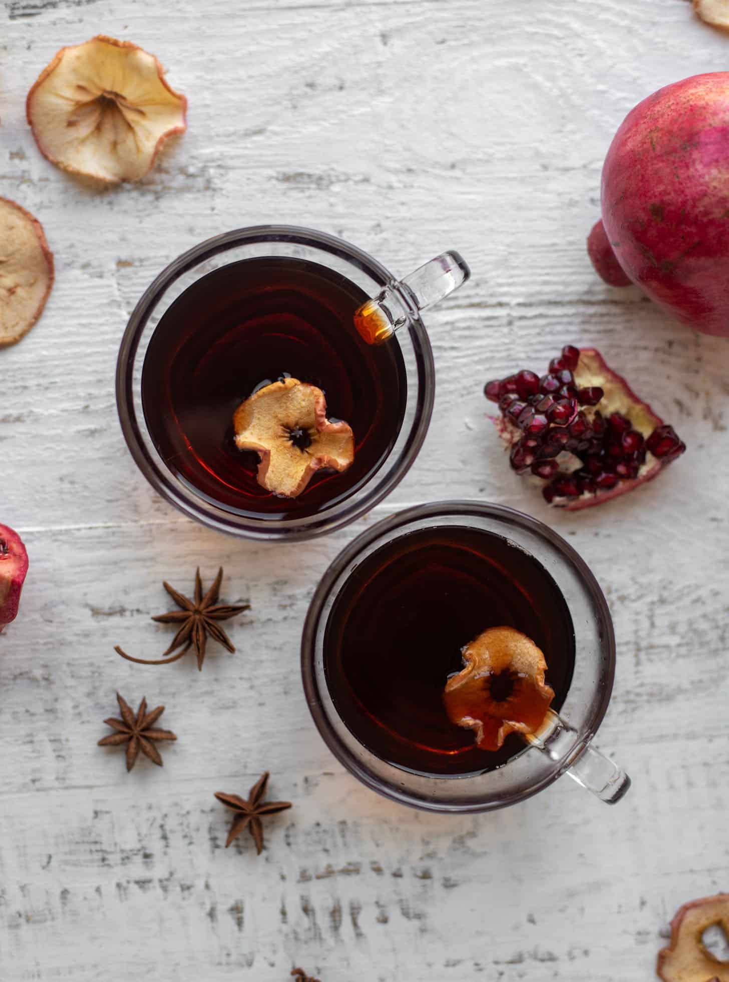 hot pomegranate cider with dried apple slices
