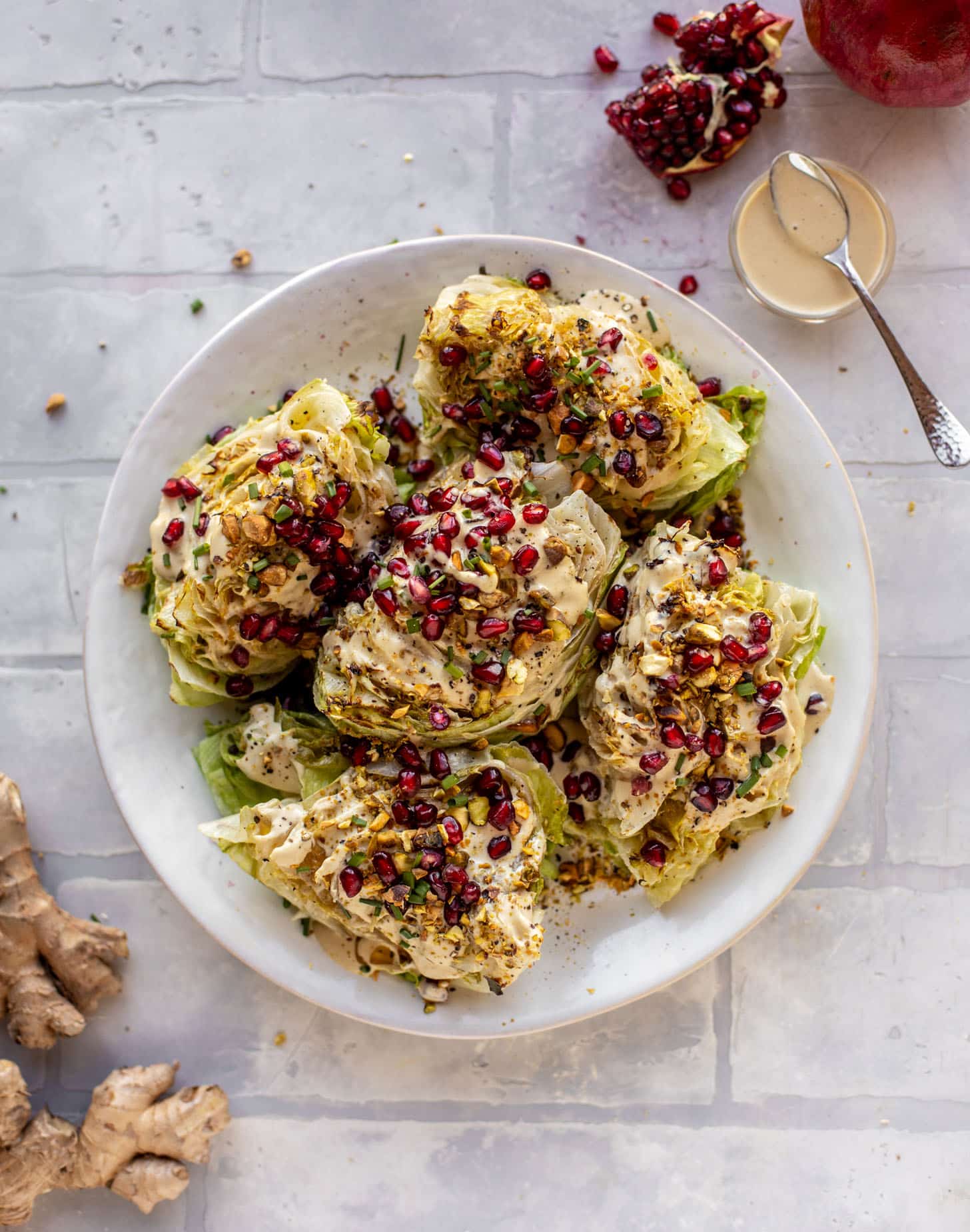 broiled wedge salad with pomegranates and pistachios