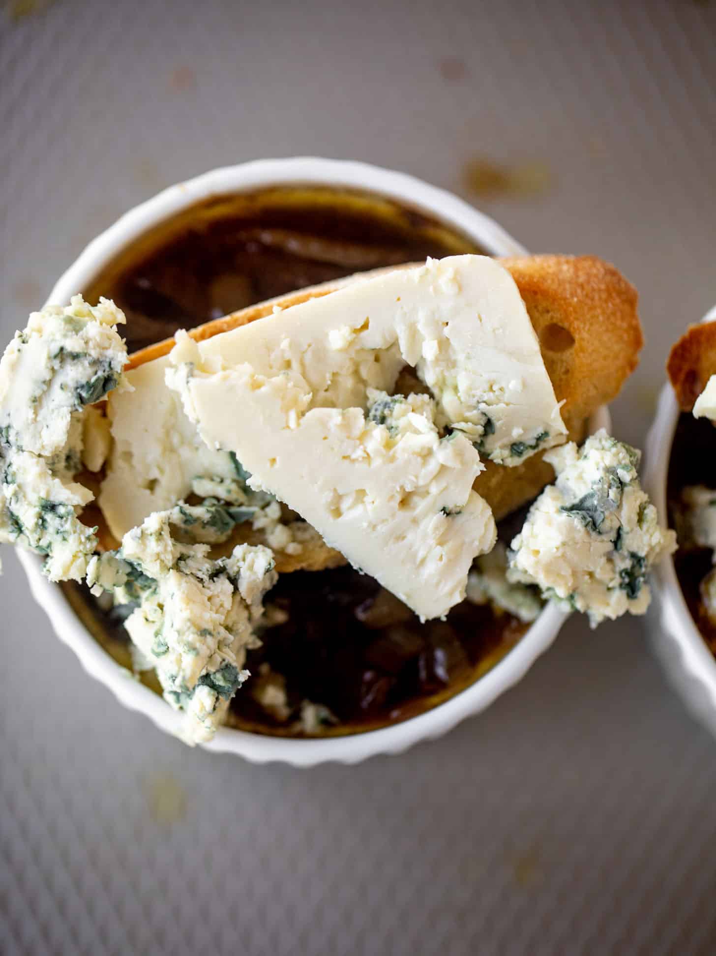french onion soup topped with baguettes and blue cheese