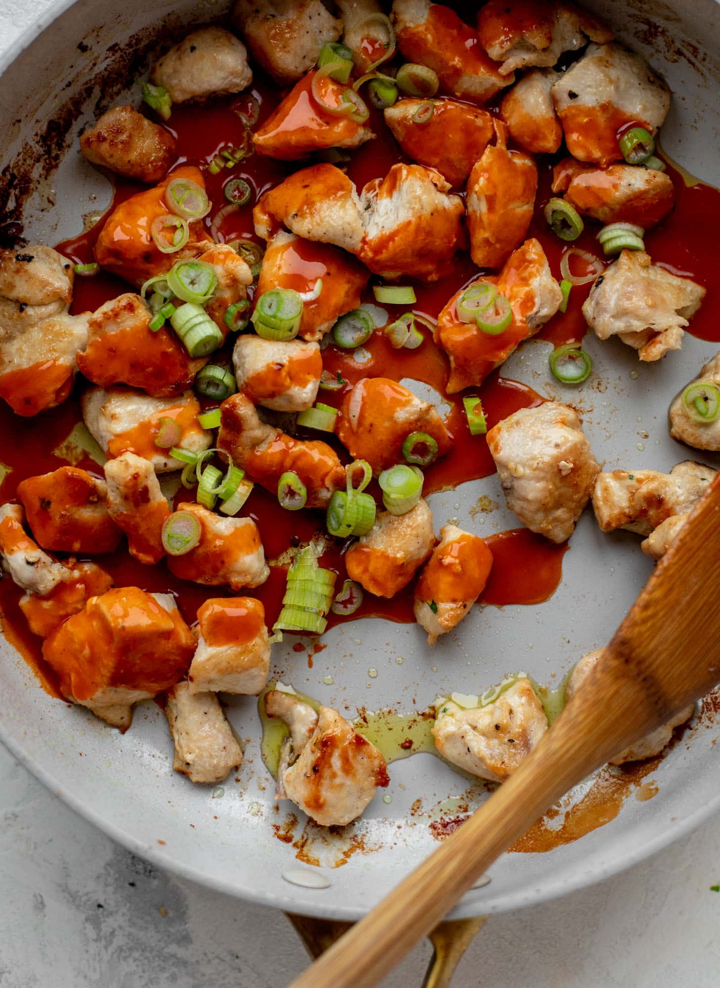 chicken with wing sauce in a skillet
