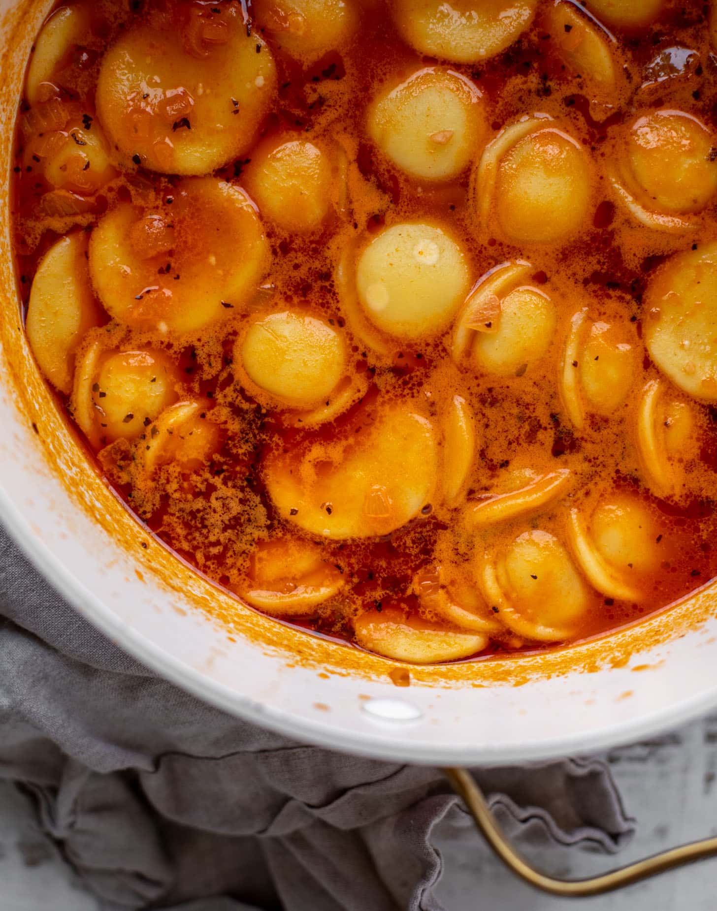 pot of tomato broth and ravioli soup