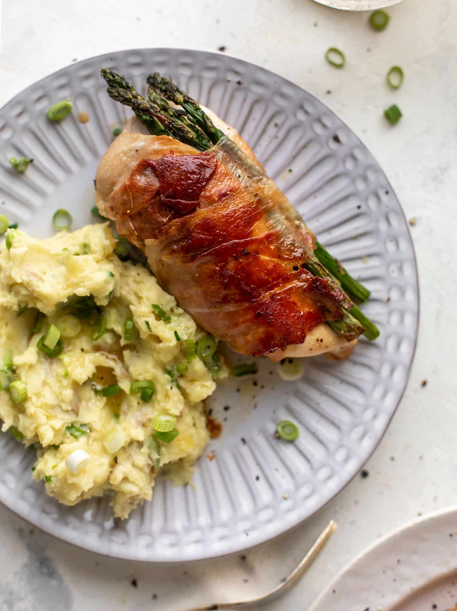 prosciutto wrapped asparagus stuffed chicken with scallion smashed potatoes