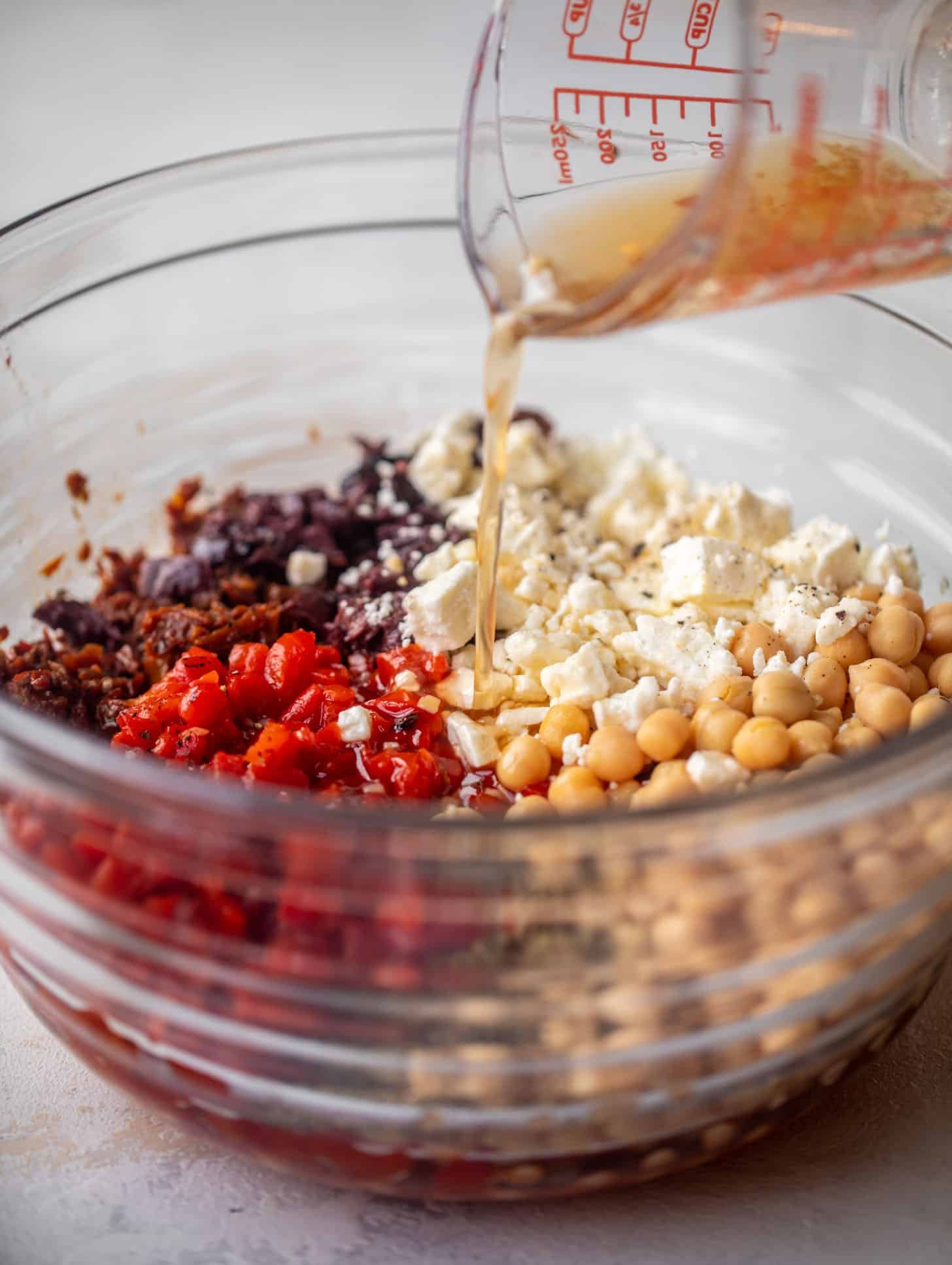 pouring vinaigrette on ingredients