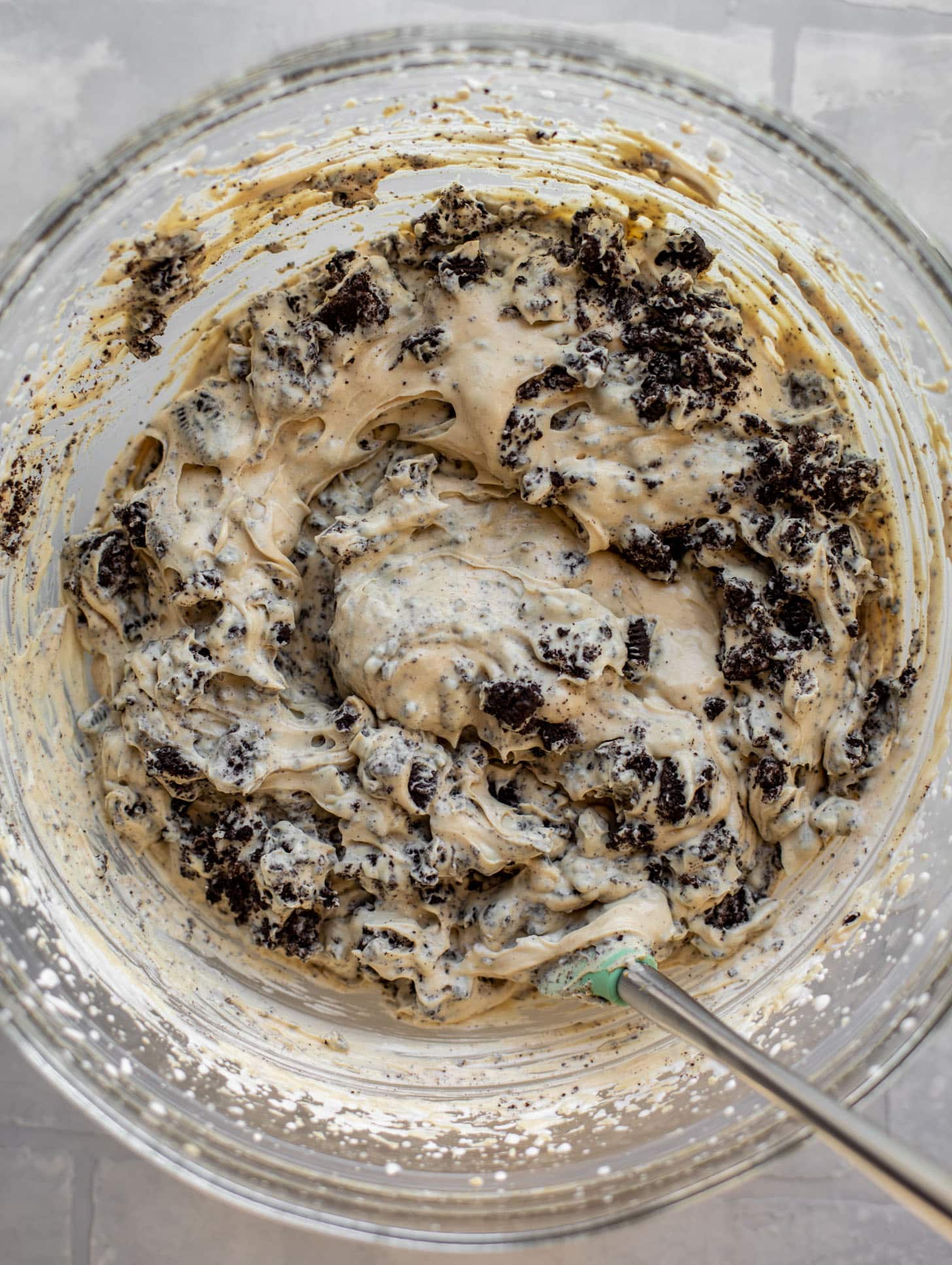 stirring oreos into peanut butter ice cream