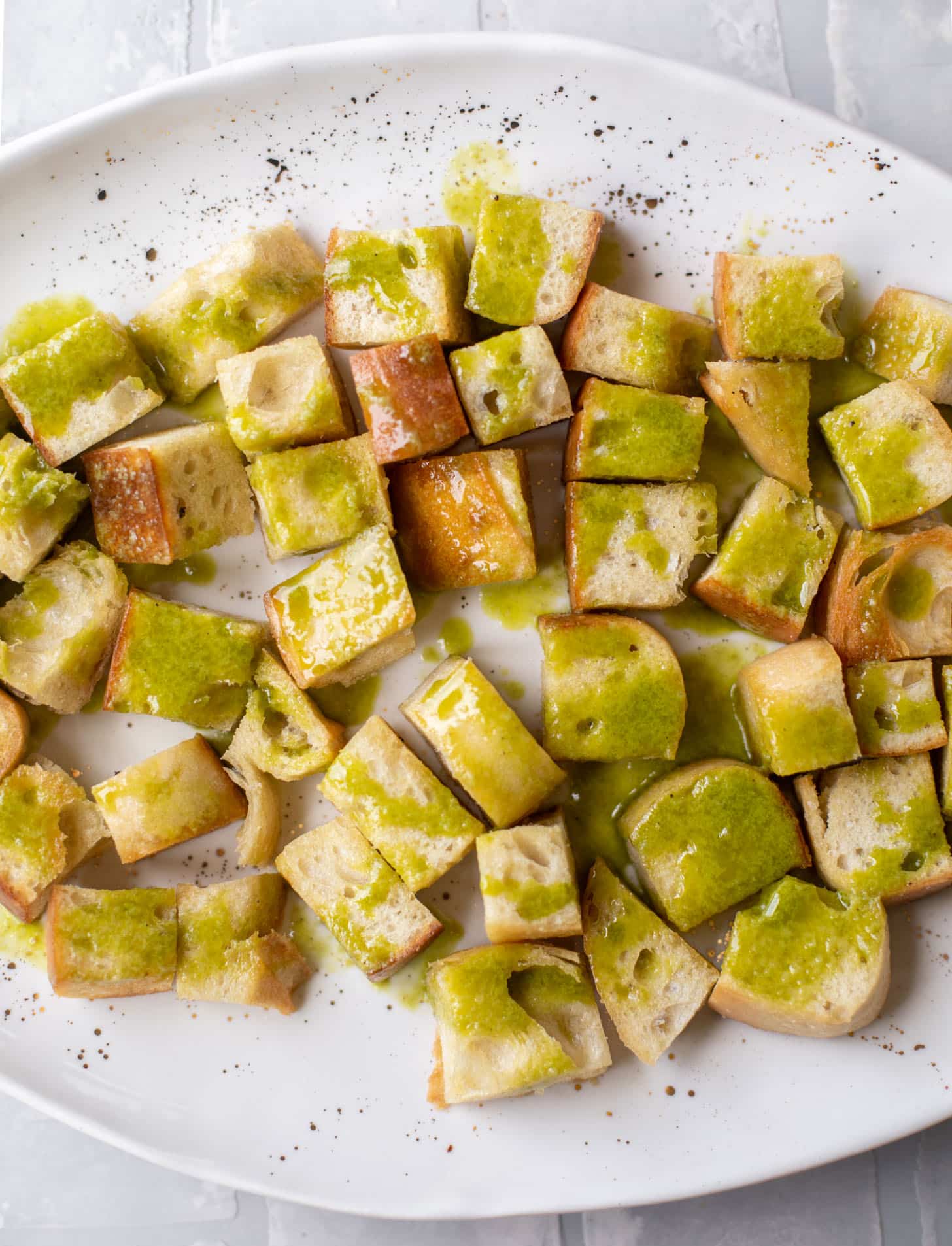bread cubes drizzled with basil vinaigrette