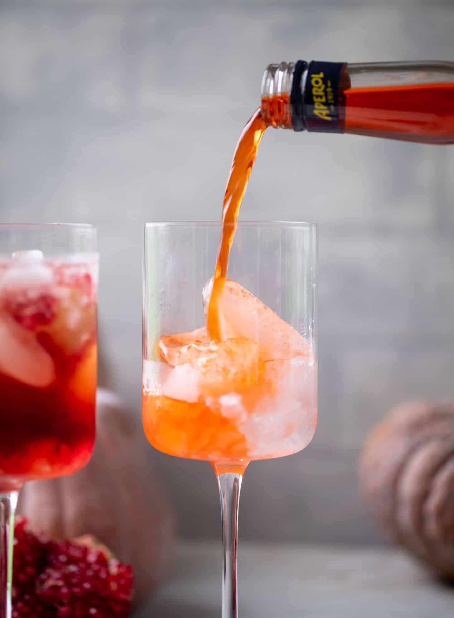 pouring aperol into a glass