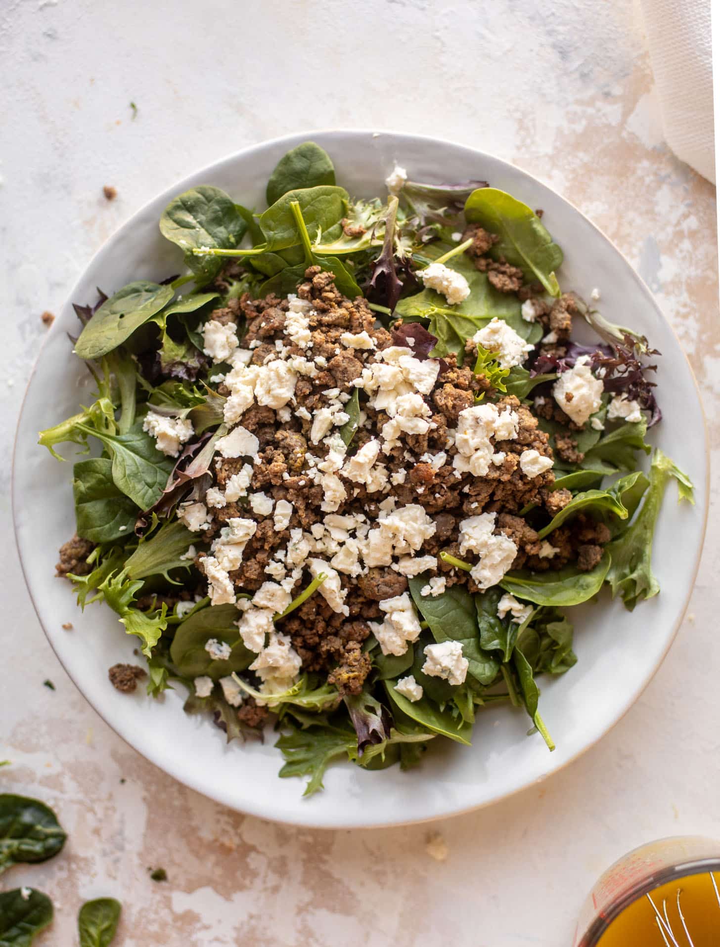 spring greens with burger and gorgonzola
