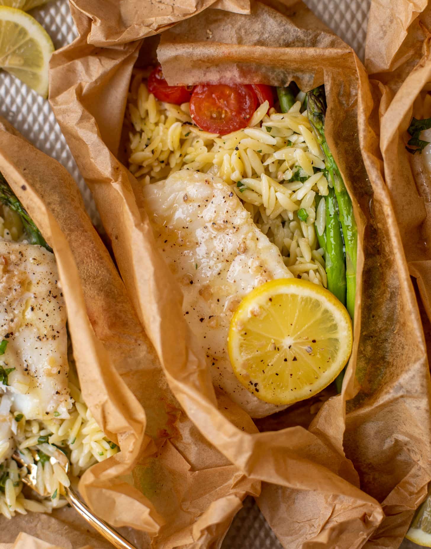 lemon garlic butter orzo and fish in parchment packet