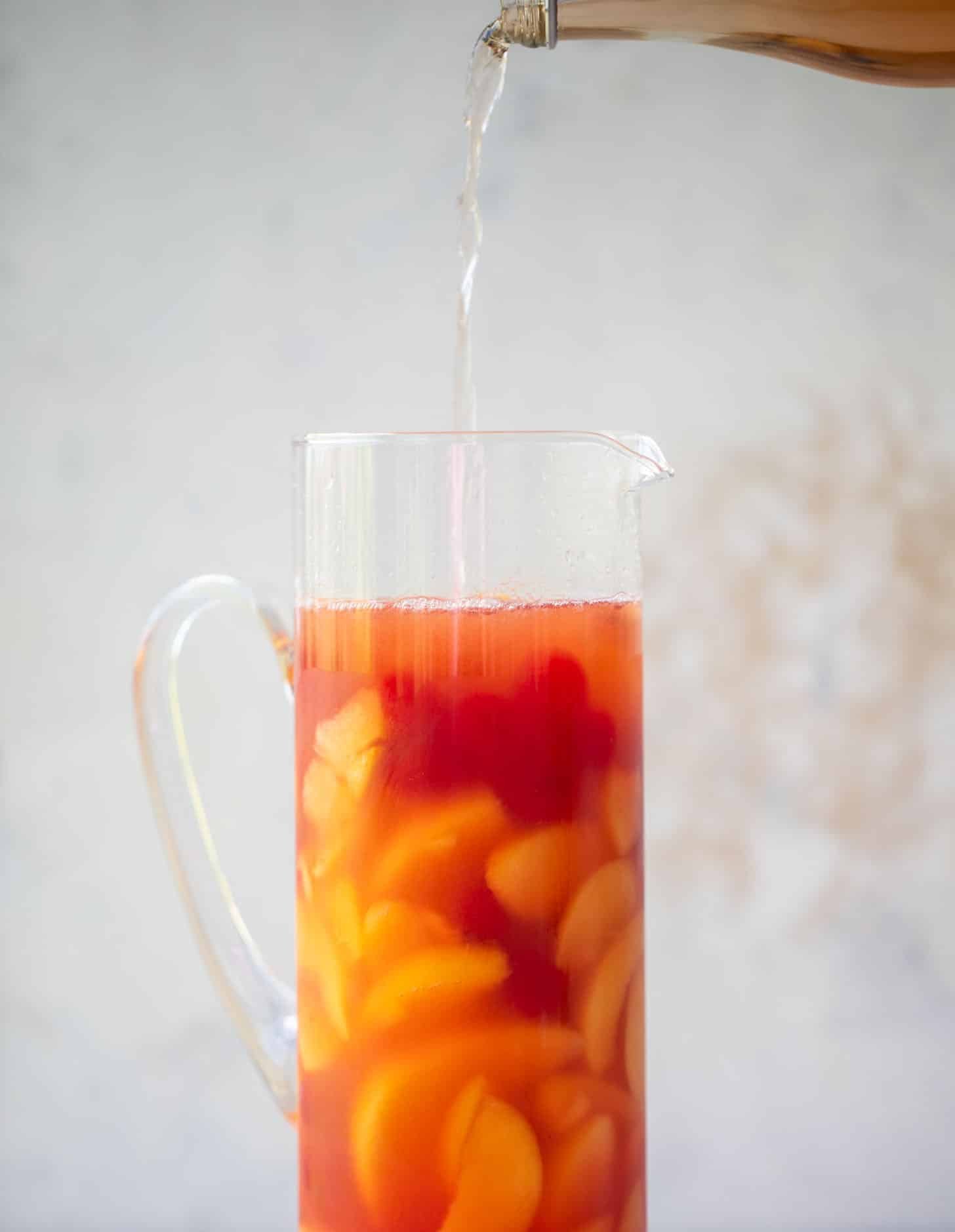 pouring sparkling rose in a pitcher