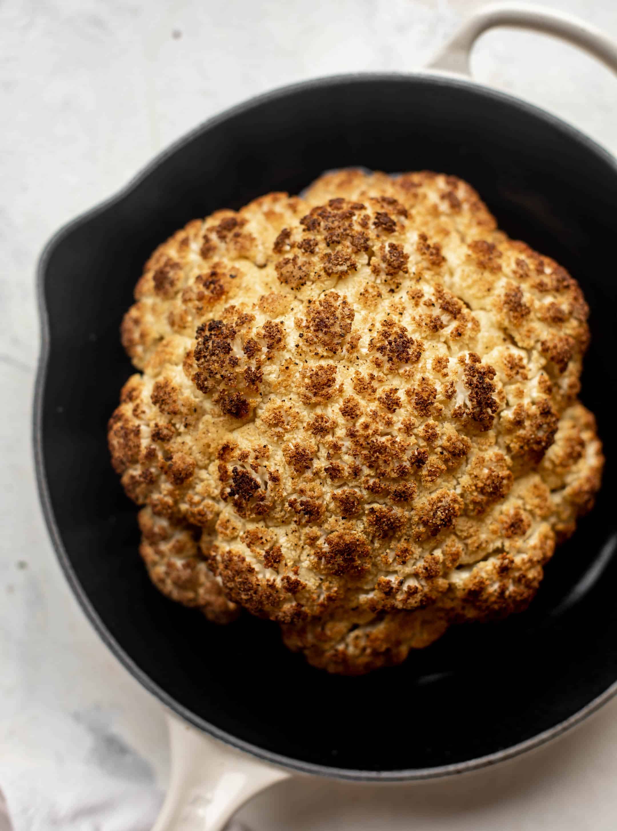 roasted cauliflower head in skillet