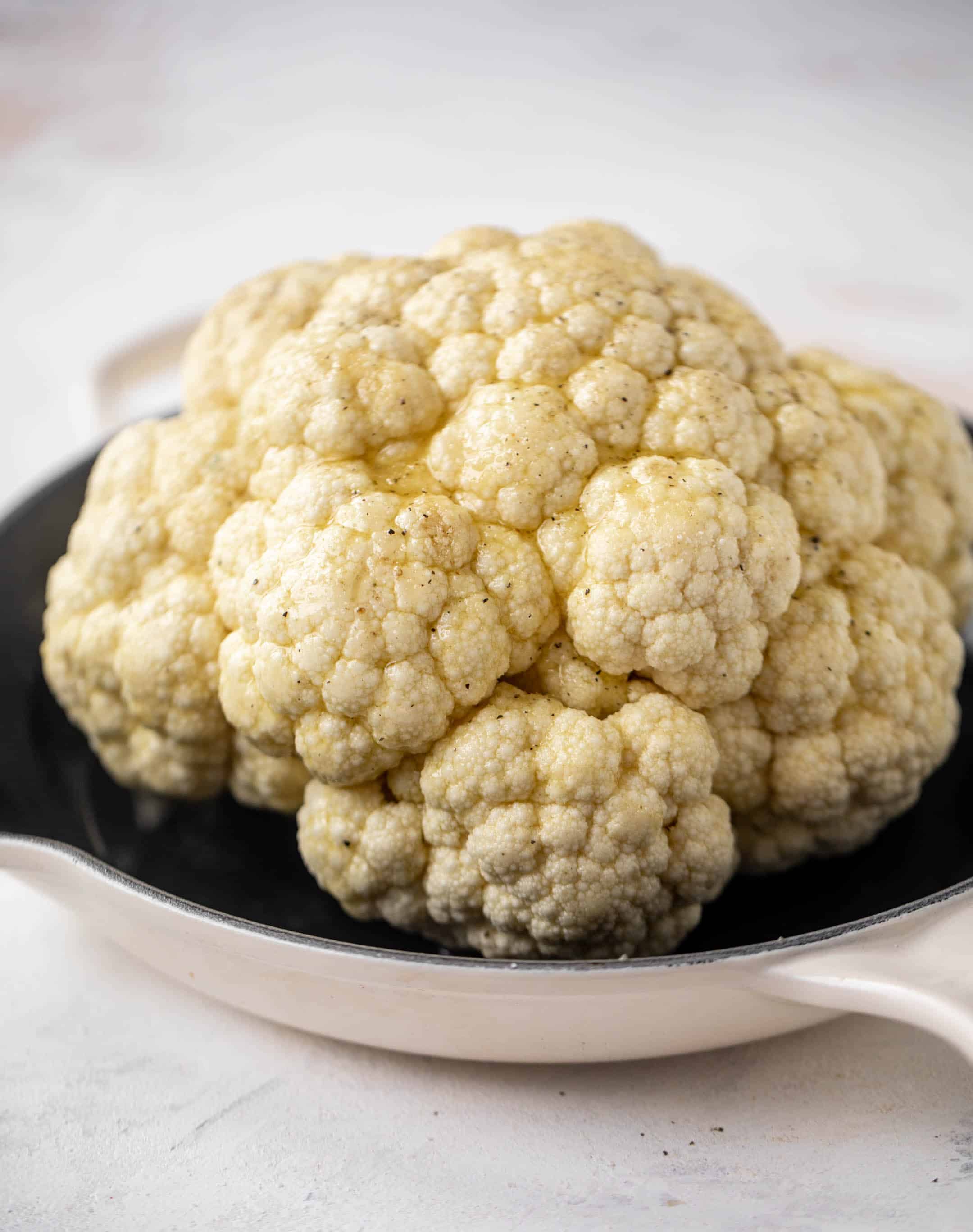 whole cauliflower in a skillet