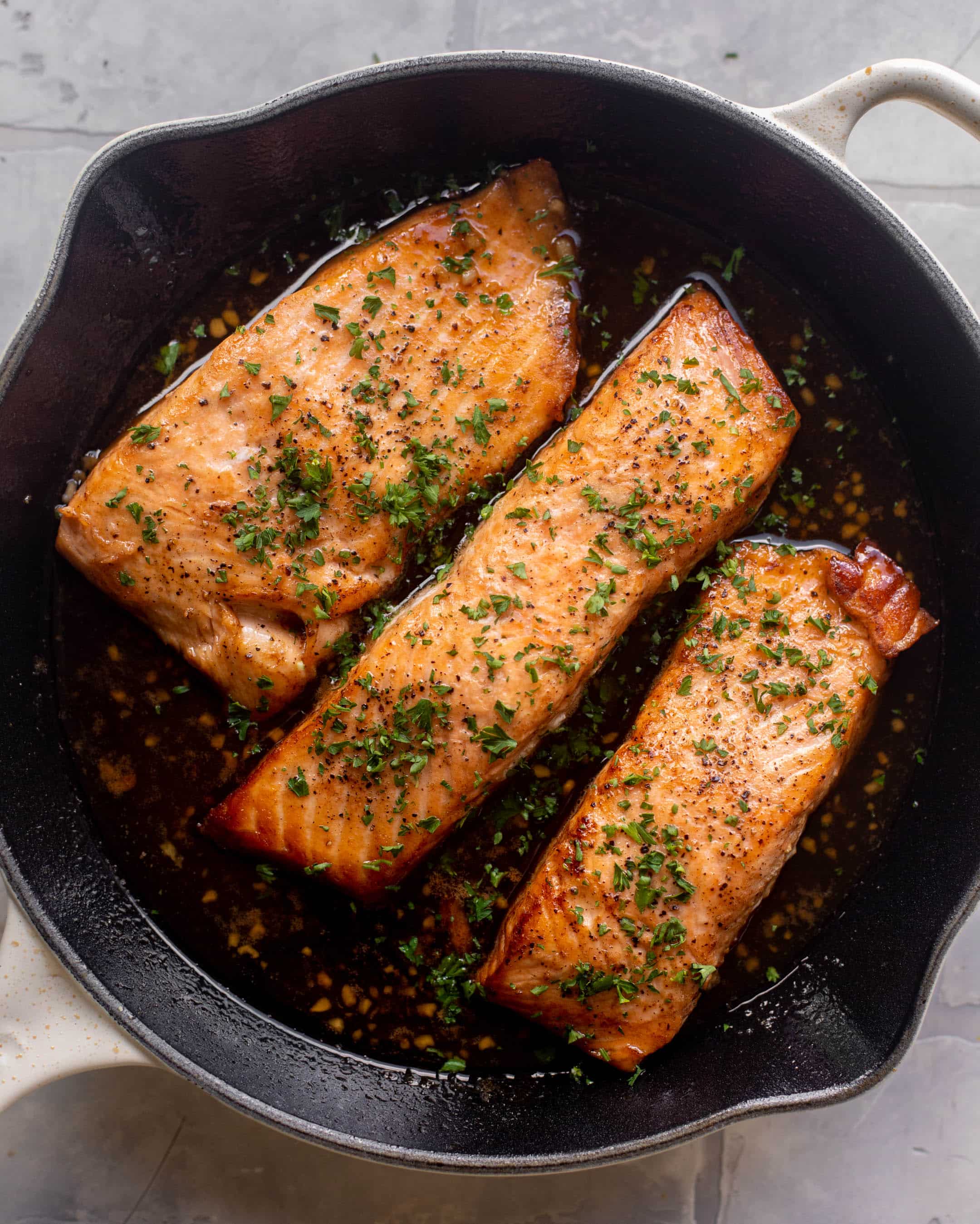 sticky garlic butter salmon in a skillet