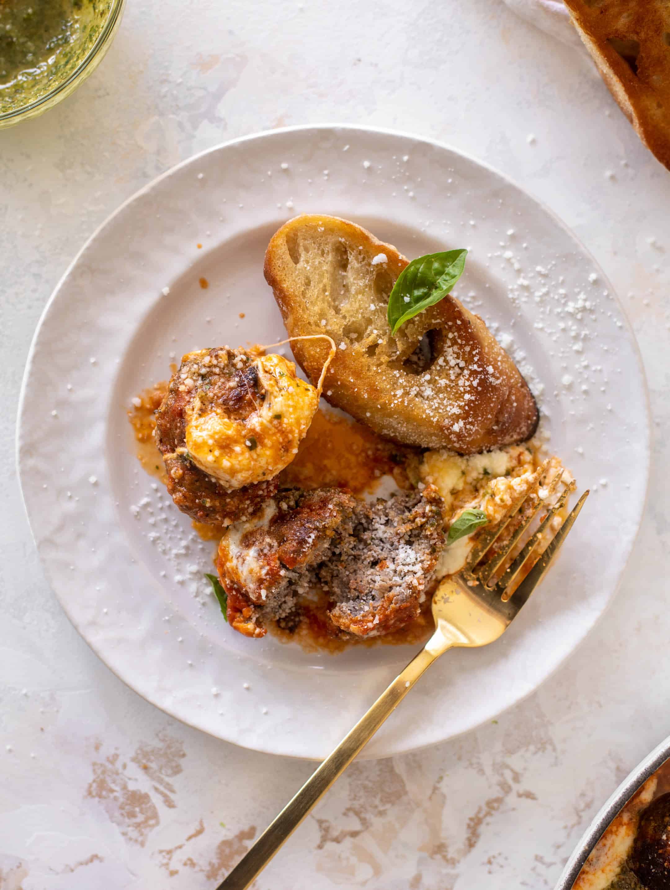 cheesy baked pesto meatballs with burrata