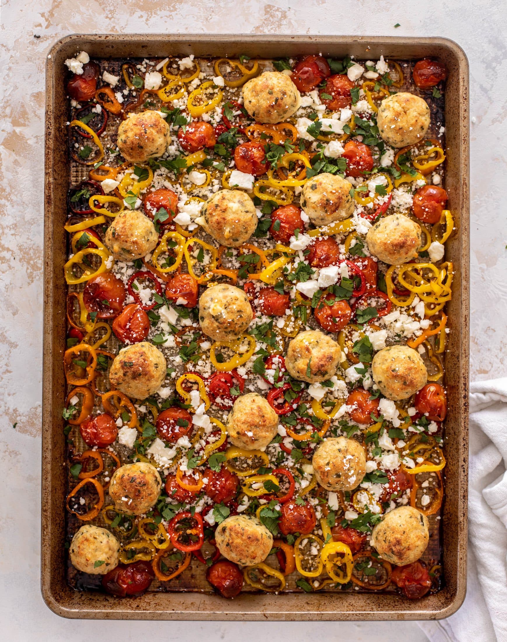 sheet pan chicken meatballs with tomatoes and feta