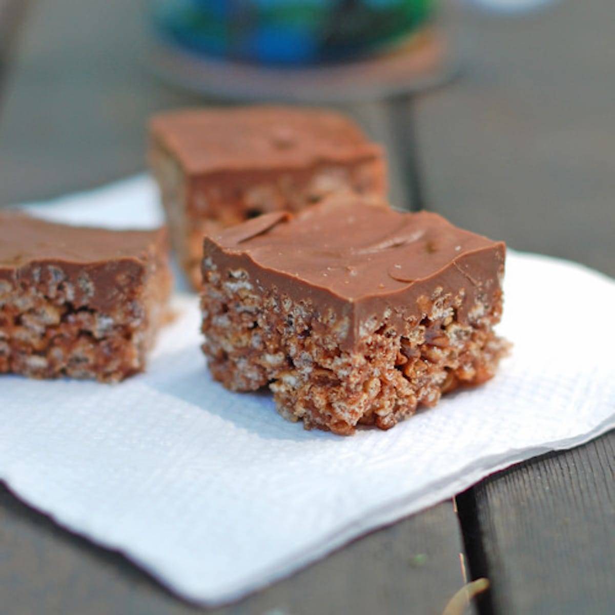 Chocolate scotcheroos on a napkin.