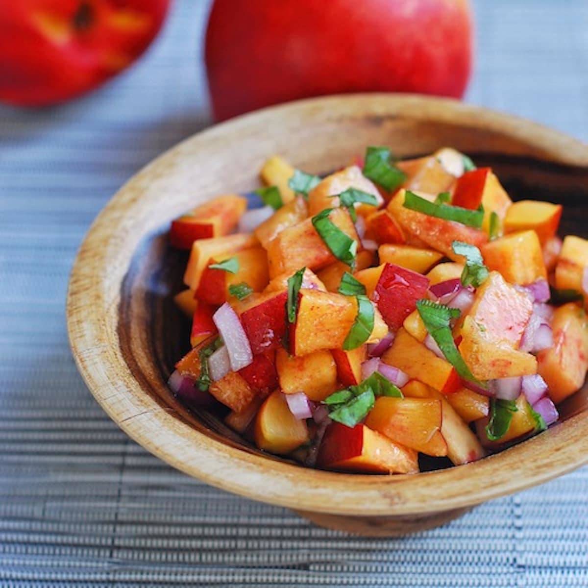 Nectarine basil salsa in a wooden bowl.