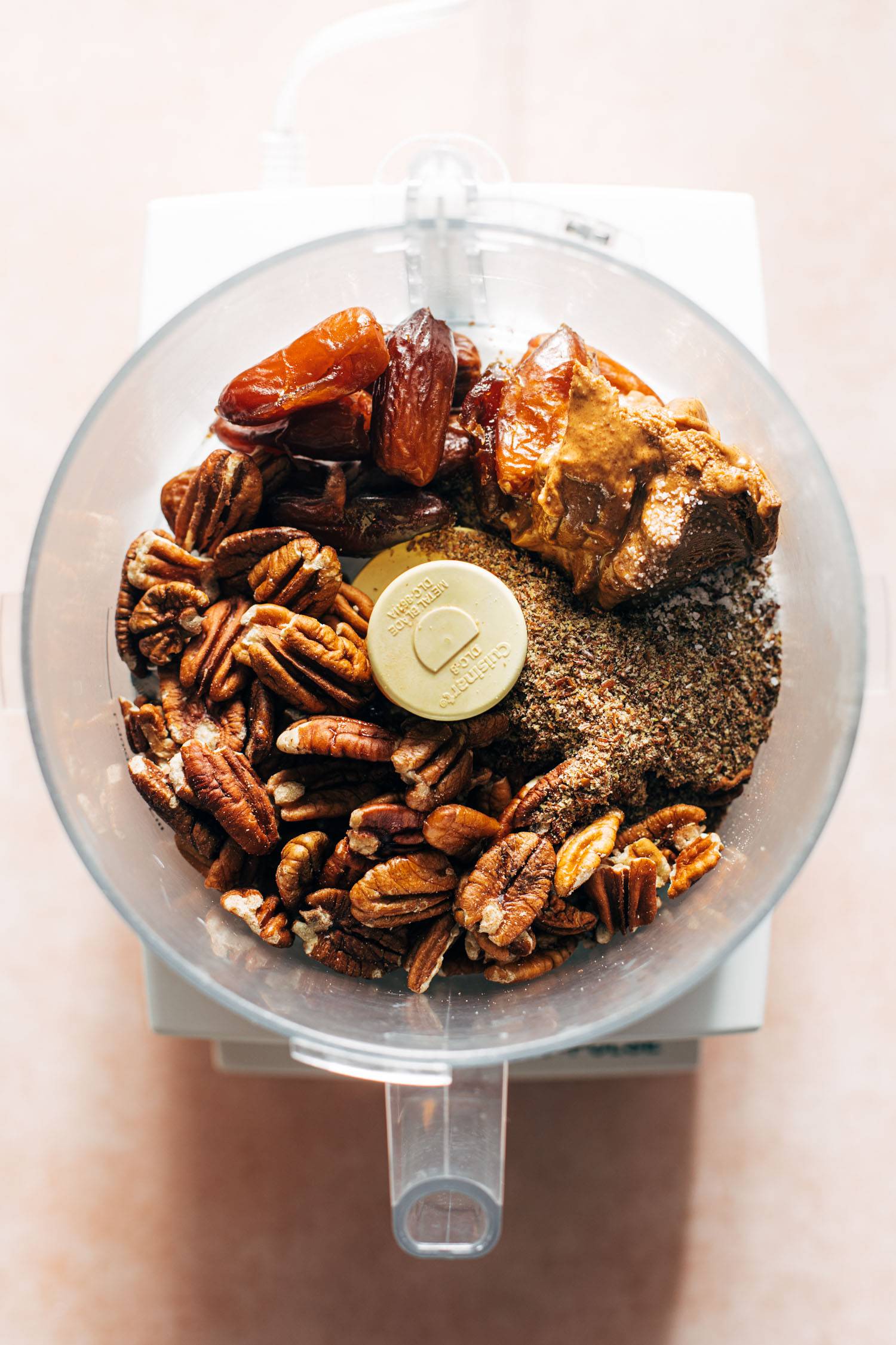 Ingredients for pecan pie energy bites in a food processor