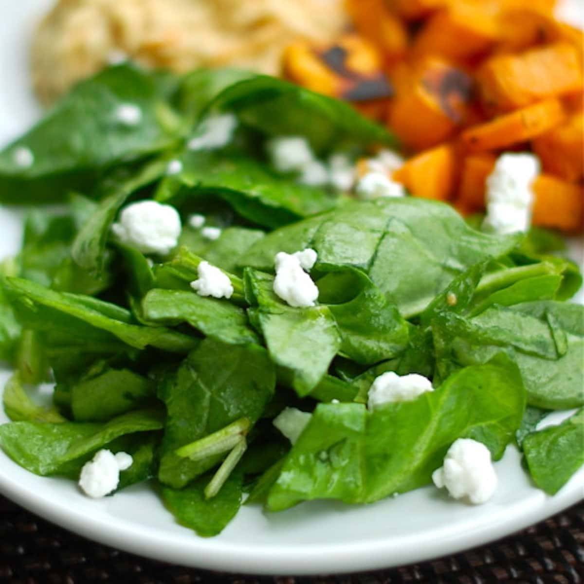 Roasted sweet potatoes  with a side of hummus and a spinach salad. 
